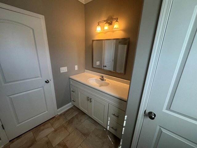 clothes washing area with laundry area, washing machine and dryer, water heater, and stone finish flooring