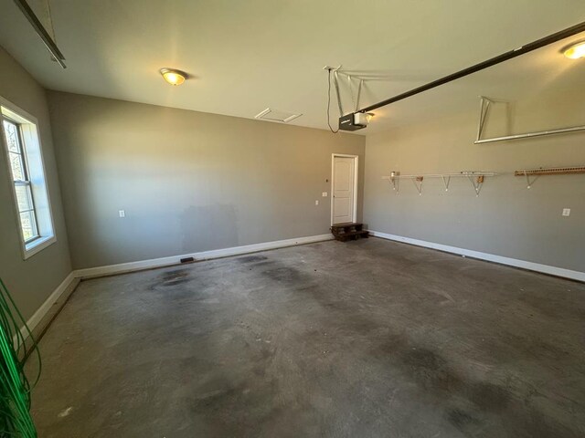 garage featuring baseboards and a garage door opener