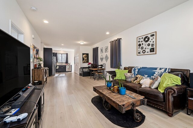 living area with recessed lighting and light wood-style flooring