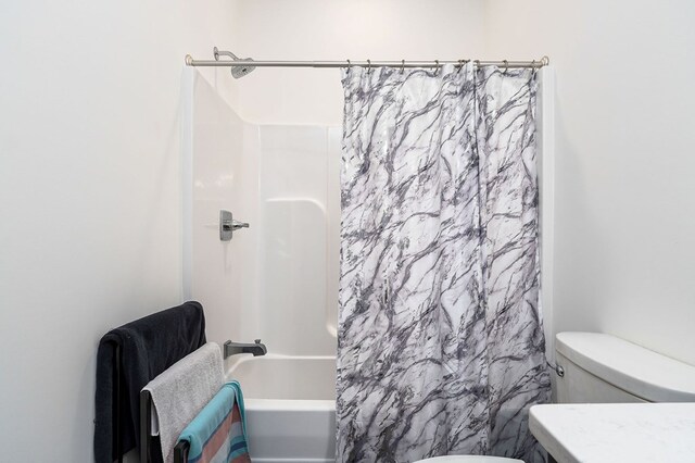 full bathroom featuring shower / bath combo and toilet