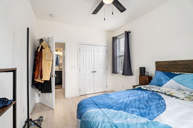 bedroom featuring a ceiling fan, light wood-type flooring, a closet, and baseboards