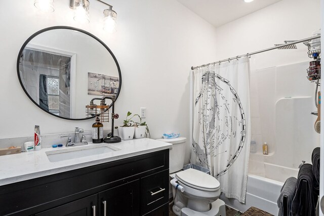 bathroom featuring shower / tub combo, vanity, and toilet