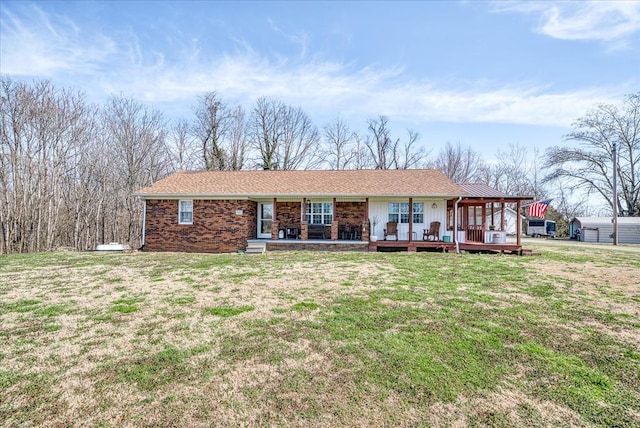 ranch-style house with a front yard, covered porch, and brick siding