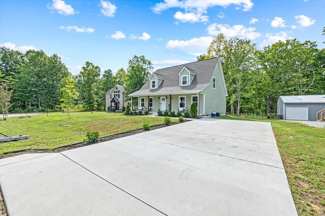 cape cod home with a porch, an outdoor structure, a detached garage, driveway, and a front lawn