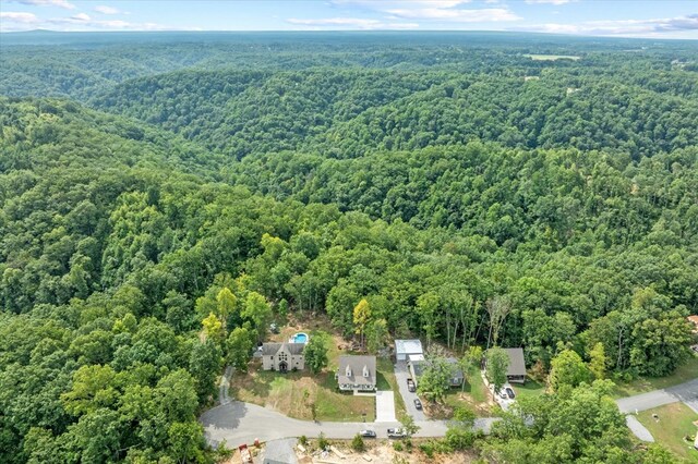 drone / aerial view featuring a wooded view