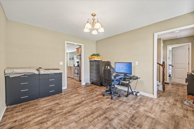 office with an inviting chandelier, wood finished floors, and baseboards