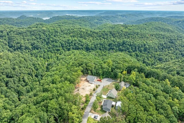 drone / aerial view featuring a wooded view