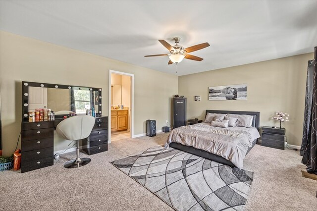 bedroom featuring connected bathroom, baseboards, a ceiling fan, and light colored carpet