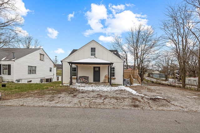 view of front of property with covered porch, stairs, and board and batten siding