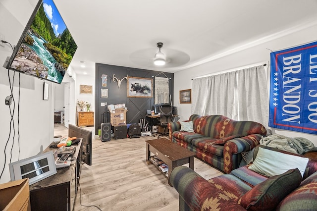 living area with ceiling fan and light wood finished floors