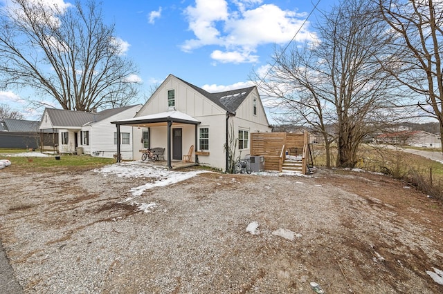 view of front of property featuring covered porch, board and batten siding, and cooling unit