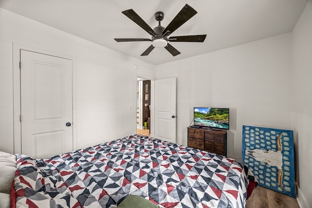 bedroom with a ceiling fan and wood finished floors