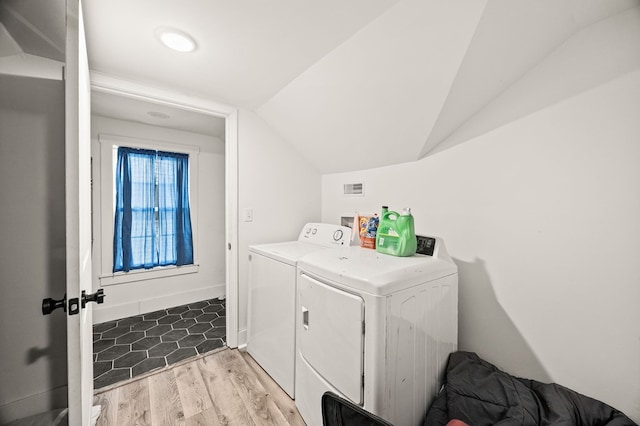 laundry room with washing machine and dryer, laundry area, baseboards, and wood finished floors