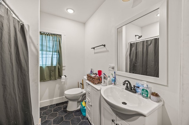 full bathroom with baseboards, a shower with shower curtain, toilet, tile patterned floors, and vanity