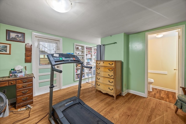 workout room with wood finished floors and baseboards