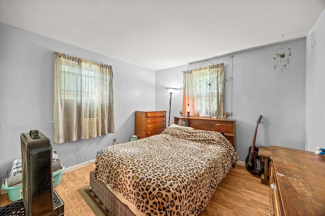 bedroom featuring light wood-type flooring and baseboards