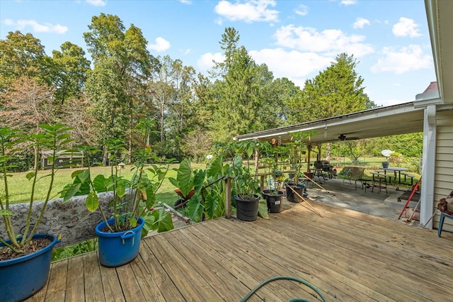 wooden deck with outdoor dining area and a yard