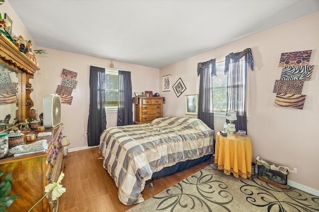 bedroom featuring wood finished floors and baseboards