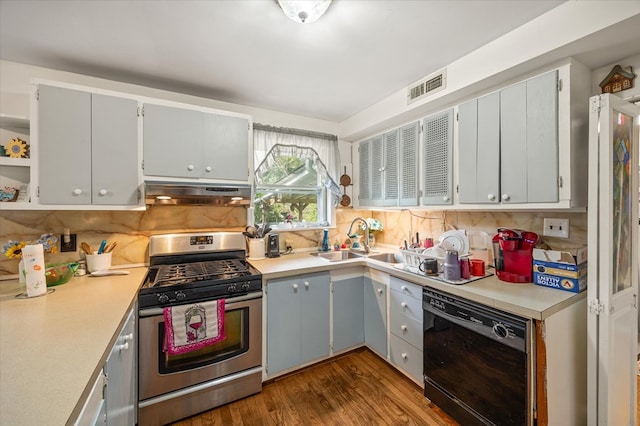 kitchen featuring light countertops, stainless steel gas stove, a sink, dishwasher, and exhaust hood