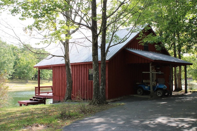 view of outbuilding featuring a water view and an outdoor structure