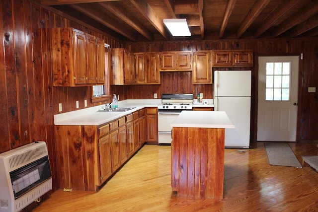 kitchen featuring light countertops, white appliances, a sink, and heating unit