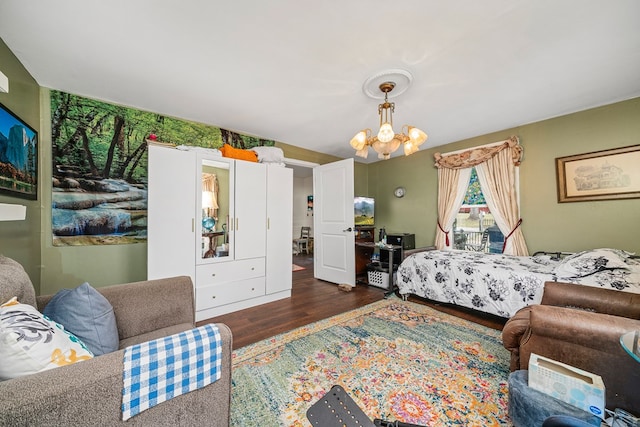 bedroom featuring a notable chandelier and wood finished floors