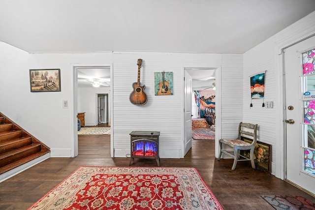 interior space featuring baseboards, wood finished floors, ceiling fan, and stairs