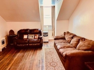 living room featuring a wealth of natural light, lofted ceiling, and hardwood / wood-style floors