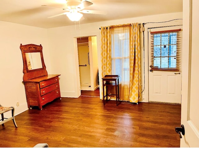 sitting room featuring wood finished floors, baseboards, and ceiling fan