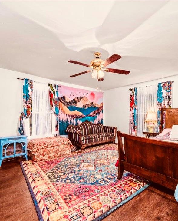 bedroom with a ceiling fan and wood finished floors