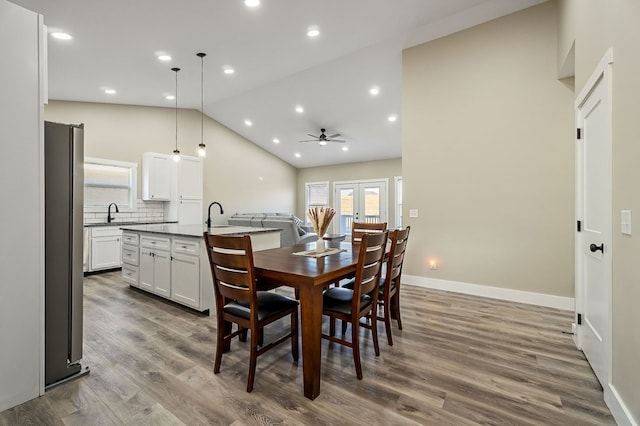 dining area featuring baseboards, vaulted ceiling, recessed lighting, french doors, and dark wood-style floors