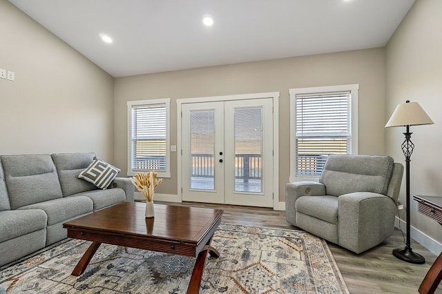 living area featuring wood finished floors, recessed lighting, french doors, and baseboards