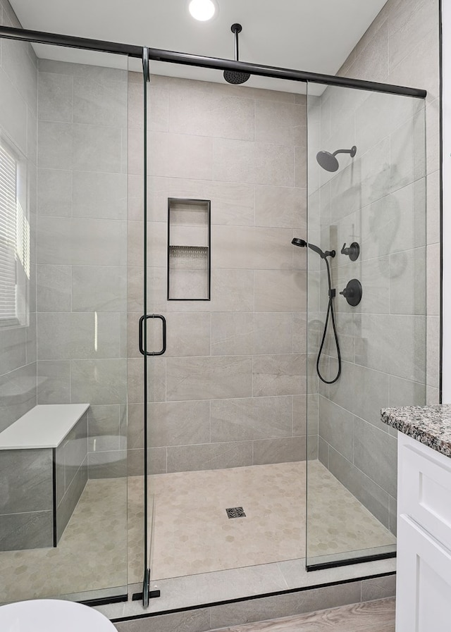 bathroom with a stall shower and vanity