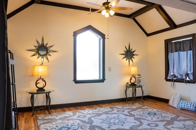 additional living space with ceiling fan, vaulted ceiling, baseboards, and wood finished floors