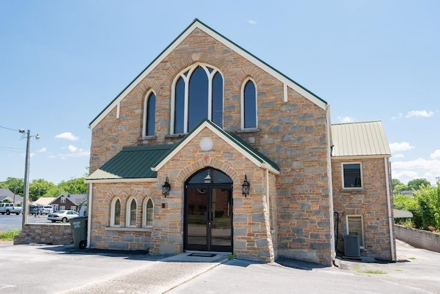 view of front facade with metal roof and french doors