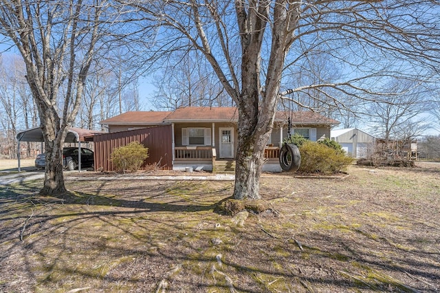 view of front of property featuring a porch and a detached carport