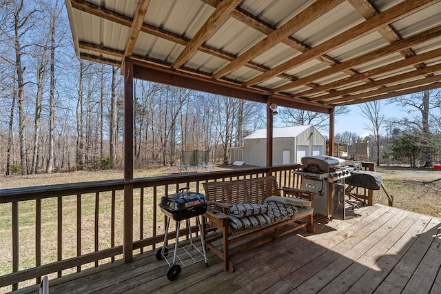 deck with an outbuilding, a trampoline, and grilling area