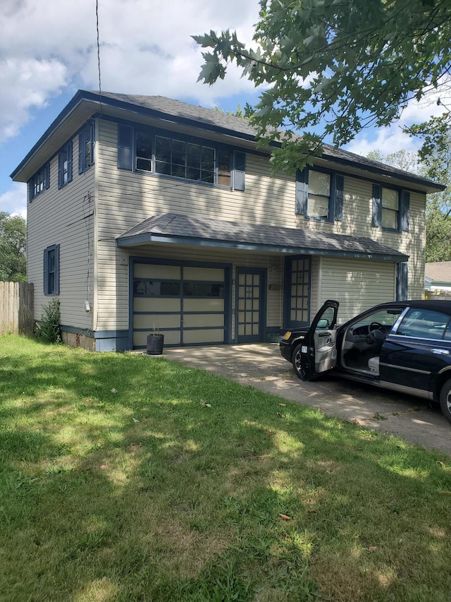 view of front of home featuring a garage and a front lawn