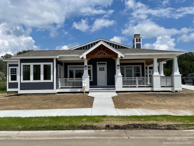 4224 Duck Dr Unit 5, Ann Arbor, MI 48103 - craftsman-style house with a porch, a shingled roof, and a chimney
