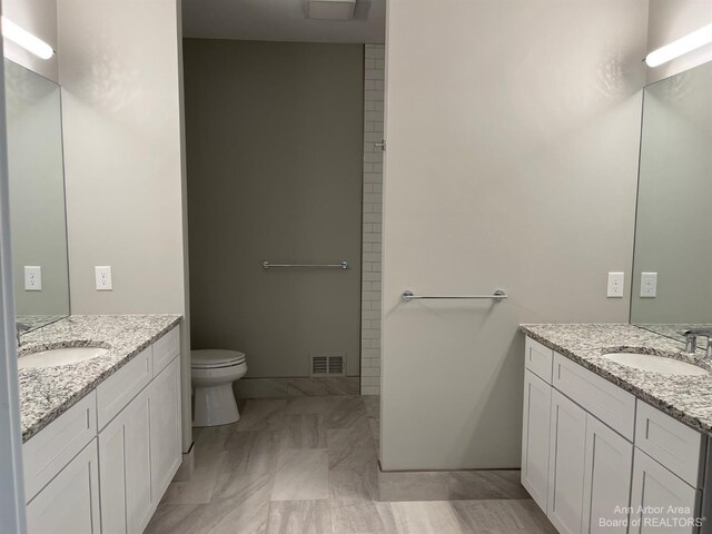 4224 Duck Dr Unit 5, Ann Arbor, MI 48103 - bathroom featuring two vanities and toilet