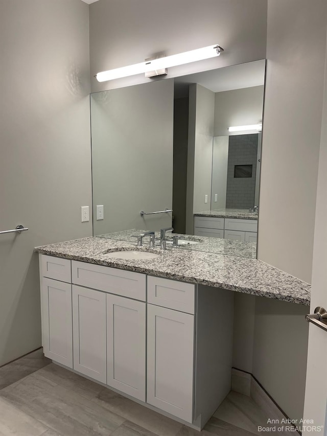 bathroom with vanity and wood-type flooring