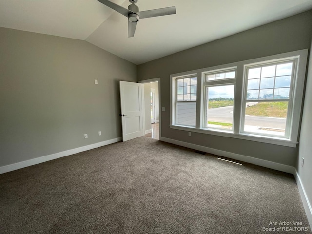 4224 Duck Dr Unit 5, Ann Arbor, MI 48103 - unfurnished bedroom featuring carpet flooring, lofted ceiling, baseboards, and a ceiling fan