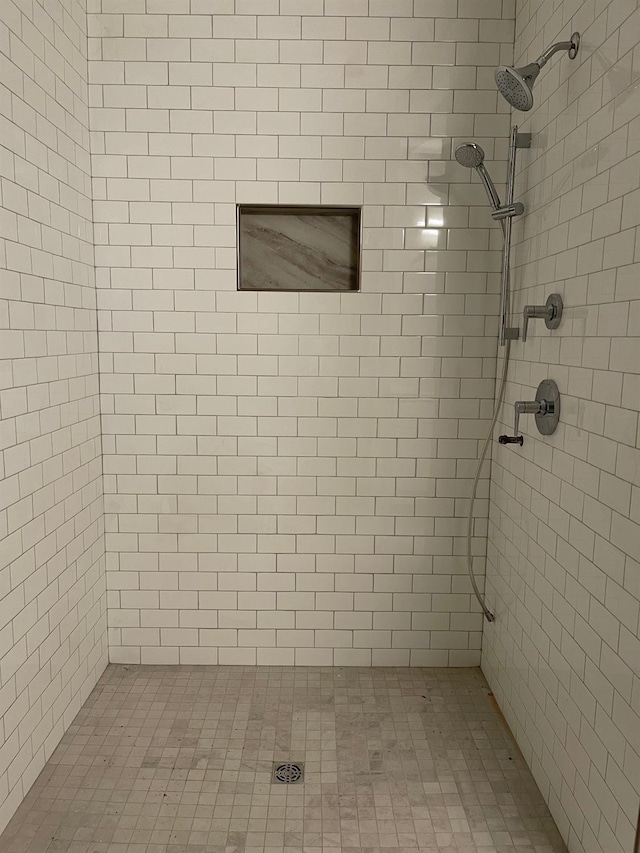 bathroom with a tile shower