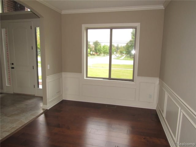 72859 Sorrel Dr, Bruce, MI 48065 - entrance foyer featuring dark wood-style flooring, arched walkways, crown molding, a wainscoted wall, and a decorative wall