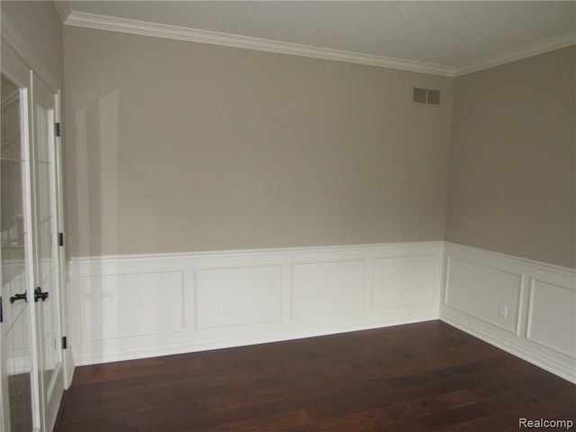 empty room with dark wood-type flooring and ornamental molding