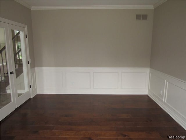 empty room with french doors, ornamental molding, and dark wood-type flooring