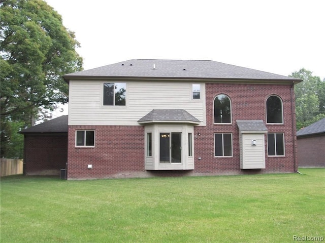 rear view of property with a yard