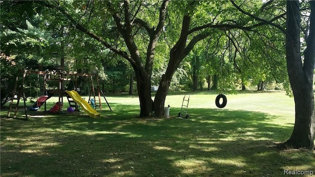 view of community with a playground and a yard