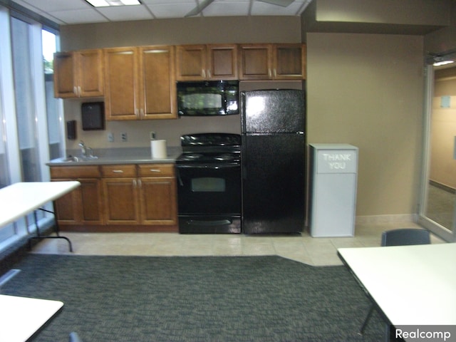 kitchen with light tile patterned floors and black appliances