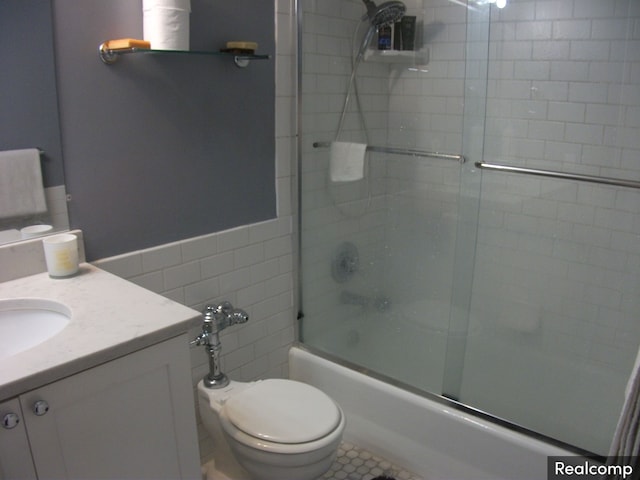 full bathroom featuring tile patterned flooring, vanity, bath / shower combo with glass door, and toilet